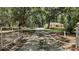 Long driveway leading up to a charming home, surrounded by lush greenery and mature trees at 11495 Se 71St Terrace Rd, Morriston, FL 32668