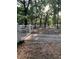 Scenic view of this wooded property featuring a private gate and white fence at 11495 Se 71St Terrace Rd, Morriston, FL 32668