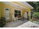 Inviting front porch with rocking chairs, bench seating and lovely landscaping at 11495 Se 71St Terrace Rd, Morriston, FL 32668