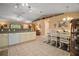 Open kitchen featuring white appliances, tile flooring, and a dining area at 11495 Se 71St Terrace Rd, Morriston, FL 32668