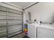 Bright laundry area featuring a washer, dryer and an open garage door at 11495 Se 71St Terrace Rd, Morriston, FL 32668