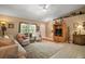 Cozy living room with neutral decor, a large window, and a comfortable seating arrangement at 11495 Se 71St Terrace Rd, Morriston, FL 32668