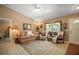 Comfortable living room with a large window, plush seating, and neutral decor at 11495 Se 71St Terrace Rd, Morriston, FL 32668