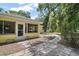 Charming home featuring a glass enclosed lanai and a welcoming stone walkway amidst a beautifully landscaped yard at 11495 Se 71St Terrace Rd, Morriston, FL 32668