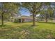 Extensive lawn with mature trees and landscaping surrounding the beautiful property at 11601 Thacker Dr, Clermont, FL 34711