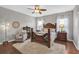 Comfortable bedroom with wood floors, a decorative bed frame, and a plush white rug at 11601 Thacker Dr, Clermont, FL 34711