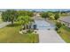 Charming single-Gathering home with a three-car garage, mature landscaping, and a well-manicured lawn at 11601 Thacker Dr, Clermont, FL 34711