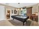 Recreation room featuring a pool table, covered in black felt, next to a sliding glass door at 11601 Thacker Dr, Clermont, FL 34711