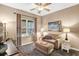 Comfortable living area featuring a cozy couch with an ottoman, large window, and stylish lamps at 11601 Thacker Dr, Clermont, FL 34711