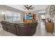 Comfortable living room with a large TV, built in cabinets, large window, and decorative clock at 11601 Thacker Dr, Clermont, FL 34711