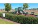 Community playground features a slide, stairs, and a bench in a well-maintained area at 11601 Thacker Dr, Clermont, FL 34711