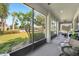 Relaxing screened-in porch with views of the manicured backyard and lush green landscaping at 11601 Thacker Dr, Clermont, FL 34711