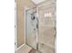 Updated bathroom featuring a glass walk-in shower with built-in shelving and tiled walls at 11601 Thacker Dr, Clermont, FL 34711