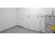 Clean basement houses the water heater and features painted concrete walls at 1228 Padgett Cir, Lady Lake, FL 32159