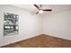 Bedroom featuring wood-look tile flooring, ceiling fan, and a window providing plenty of natural light at 1228 Padgett Cir, Lady Lake, FL 32159