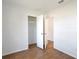 Neutral bedroom boasts wood-look flooring, closet, and access to the hallway at 1228 Padgett Cir, Lady Lake, FL 32159