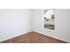 Light-filled bedroom with wood-look tile flooring and large window at 1228 Padgett Cir, Lady Lake, FL 32159
