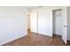 Neutral bedroom boasts wood-look flooring, closet, and access to the hallway at 1228 Padgett Cir, Lady Lake, FL 32159