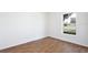 Bright bedroom with wood-look tile flooring and large window at 1228 Padgett Cir, Lady Lake, FL 32159
