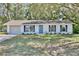 Charming single-story home with a well-maintained front yard, and a driveway leading to an attached garage at 1228 Padgett Cir, Lady Lake, FL 32159