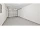 Spacious and clean two-car garage with block walls and concrete floor at 1228 Padgett Cir, Lady Lake, FL 32159
