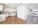 Modern kitchen with white cabinets, stainless steel appliances, granite countertops, and wood-look tile flooring at 1228 Padgett Cir, Lady Lake, FL 32159