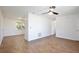 Open-concept living room featuring wood-look tile flooring, ceiling fan, and plenty of natural light at 1228 Padgett Cir, Lady Lake, FL 32159