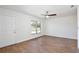 Bright living room featuring wood-look tile flooring, ceiling fan, and a window providing ample natural light at 1228 Padgett Cir, Lady Lake, FL 32159