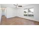 Bright living room featuring wood-look tile flooring, ceiling fan, a closet, and a window providing ample natural light at 1228 Padgett Cir, Lady Lake, FL 32159