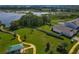 Aerial view showcasing the home's proximity to waterfront, a park, and a walking trail at 124 Juno Dr, Groveland, FL 34736
