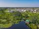Aerial view showcases the serene community with ponds, walking trails, and lush greenery at 124 Juno Dr, Groveland, FL 34736