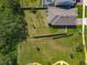 Aerial view of a home with a large backyard bordering a walking trail and park at 124 Juno Dr, Groveland, FL 34736