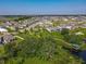 An aerial view of a well maintained community featuring sidewalks, a gazebo, and a walking bridge at 124 Juno Dr, Groveland, FL 34736