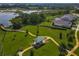 Community aerial view featuring a walking path, gazebo and lush landscaping near a lake at 124 Juno Dr, Groveland, FL 34736