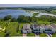 Beautiful aerial view of homes near a lake and boardwalk trails on a sunny day at 124 Juno Dr, Groveland, FL 34736