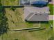 An aerial view displaying the property and its spacious lot in relation to neighbors at 124 Juno Dr, Groveland, FL 34736