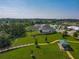 An aerial view shows nearby homes and common green areas, allowing potential buyers to understand the neighborhood at 124 Juno Dr, Groveland, FL 34736
