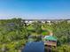 An aerial view of the community park shows the bridge, walking path, lily pond, and gazebo at 124 Juno Dr, Groveland, FL 34736