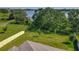 Spacious backyard with mature trees, a scenic lake view, and a charming gazebo on the water at 124 Juno Dr, Groveland, FL 34736