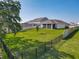 Spacious backyard featuring a well-maintained lawn and black metal fence at 124 Juno Dr, Groveland, FL 34736