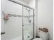 Tiled walk-in shower with sliding glass doors and built in shelving at 124 Juno Dr, Groveland, FL 34736