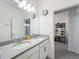 Double vanity bathroom with granite countertops and tiled flooring at 124 Juno Dr, Groveland, FL 34736