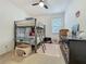 Bedroom with bunk bed, ceiling fan, area rug, desk, and dresser at 124 Juno Dr, Groveland, FL 34736