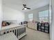 Well lit bedroom with carpet, ceiling fan, closet, and two windows with blinds at 124 Juno Dr, Groveland, FL 34736