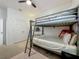 Bedroom with bunk bed, ceiling fan, area rug, desk, and dresser at 124 Juno Dr, Groveland, FL 34736