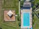 Birds eye view of the community pool and playground with palm trees and lots of room for activities at 124 Juno Dr, Groveland, FL 34736