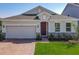 Charming single-Gathering home featuring brick driveway and two-car garage in a well-kept lawn at 124 Juno Dr, Groveland, FL 34736