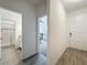 Hallway providing access to the front door, bathroom, and living areas at 124 Juno Dr, Groveland, FL 34736