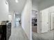 Bright hallway with gray floors and doors leading to rooms in a comfortable home at 124 Juno Dr, Groveland, FL 34736