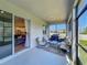 Relaxing lanai featuring outdoor seating, a grill, and a view of the home's interior at 124 Juno Dr, Groveland, FL 34736